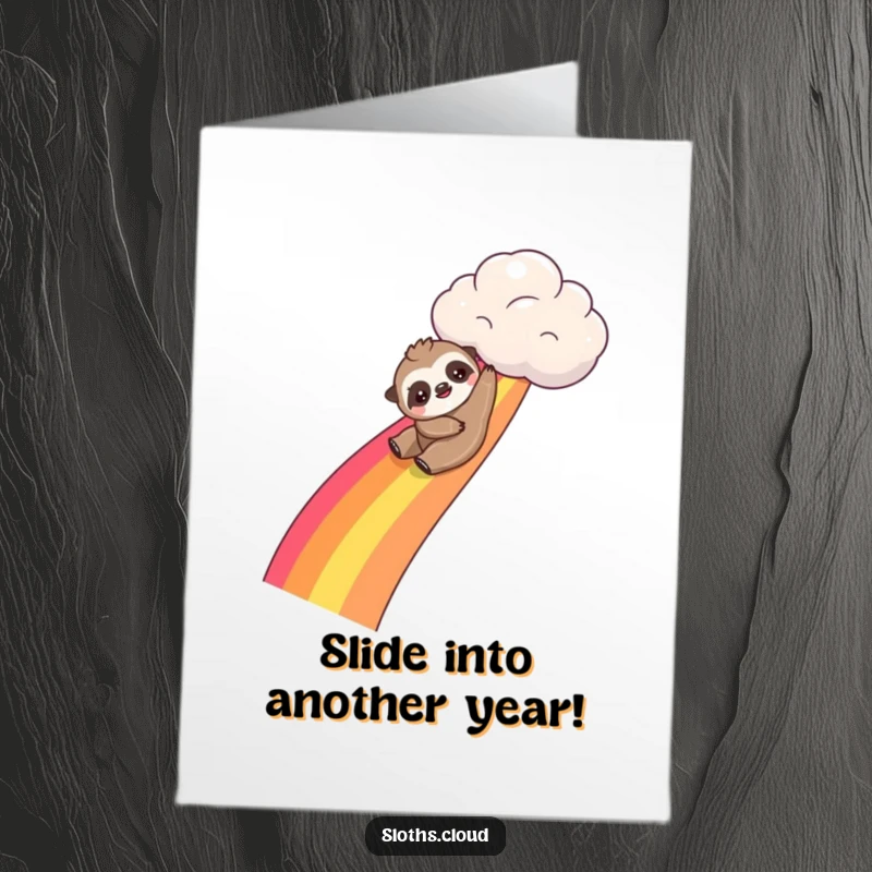 Funny free printable birthday card: Kawaii sloth playfully sliding down a bright rainbow originating from a fluffy cloud.