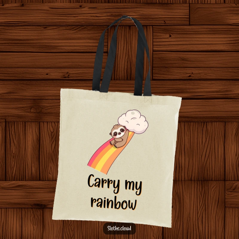 Funny kawaii sloth tote bag showing a cute sloth sliding down a rainbow from a cloud, great for carrying items with a playful vibe.